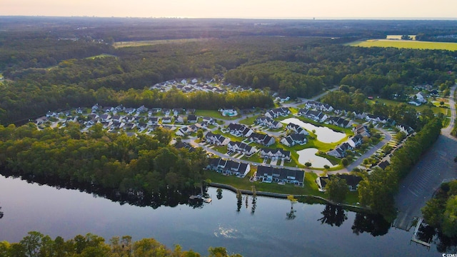 aerial view at dusk featuring a water view