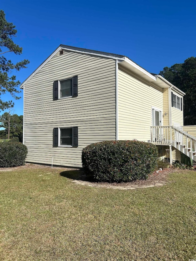 view of side of home featuring a yard