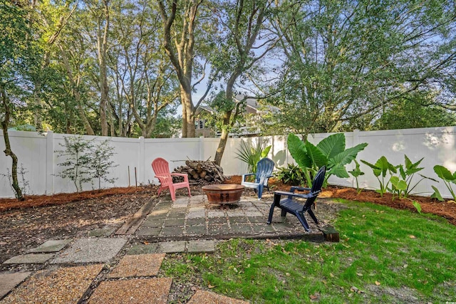 view of yard featuring a patio area, a fire pit, and a fenced backyard