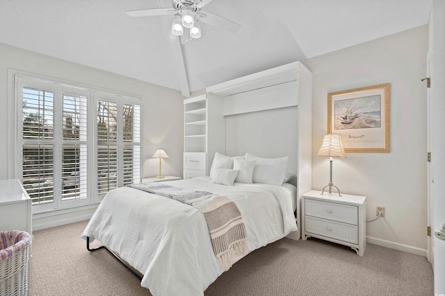 bedroom with light colored carpet, a ceiling fan, baseboards, and lofted ceiling