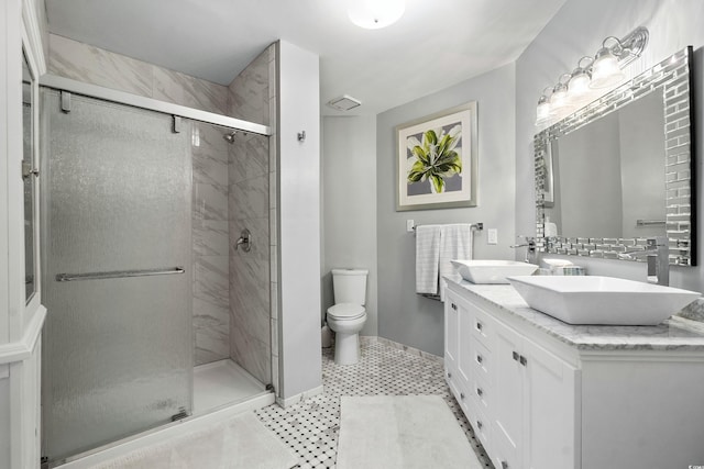 bathroom with vanity, an enclosed shower, and toilet