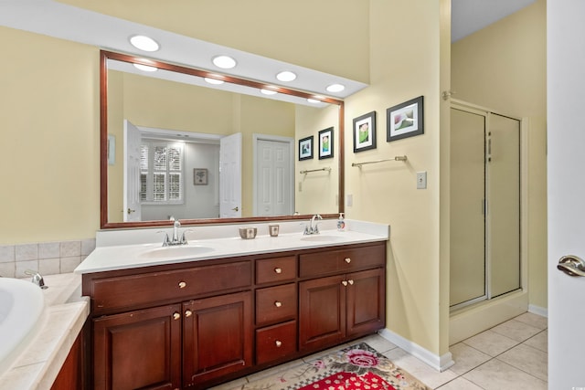 bathroom with vanity, shower with separate bathtub, and tile patterned flooring