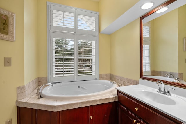 bathroom with a relaxing tiled tub and vanity