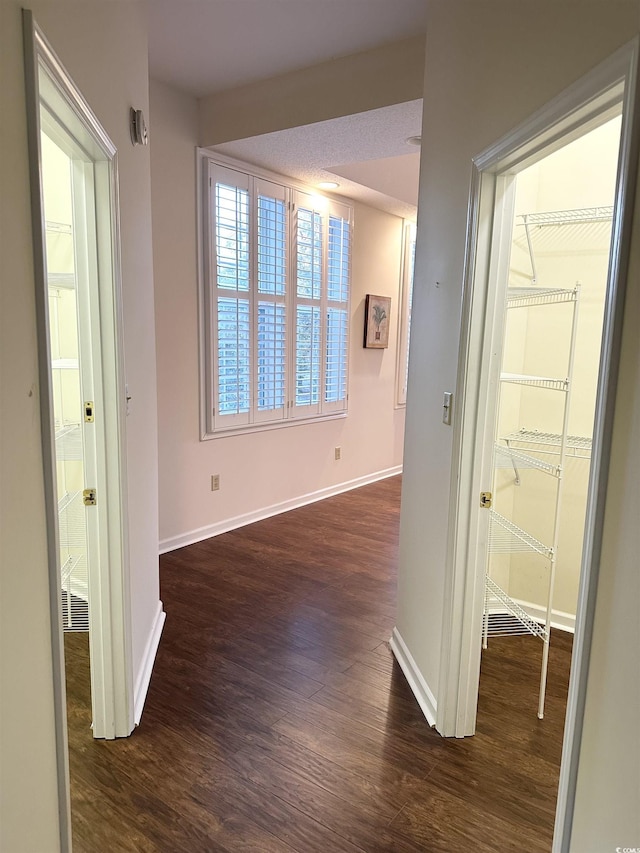 corridor featuring dark hardwood / wood-style floors