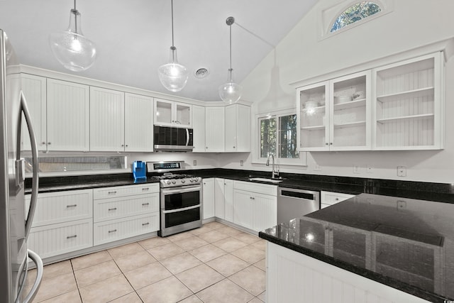 kitchen with light tile patterned floors, sink, appliances with stainless steel finishes, white cabinetry, and hanging light fixtures