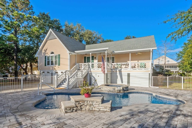 view of pool with an in ground hot tub, ceiling fan, and a patio