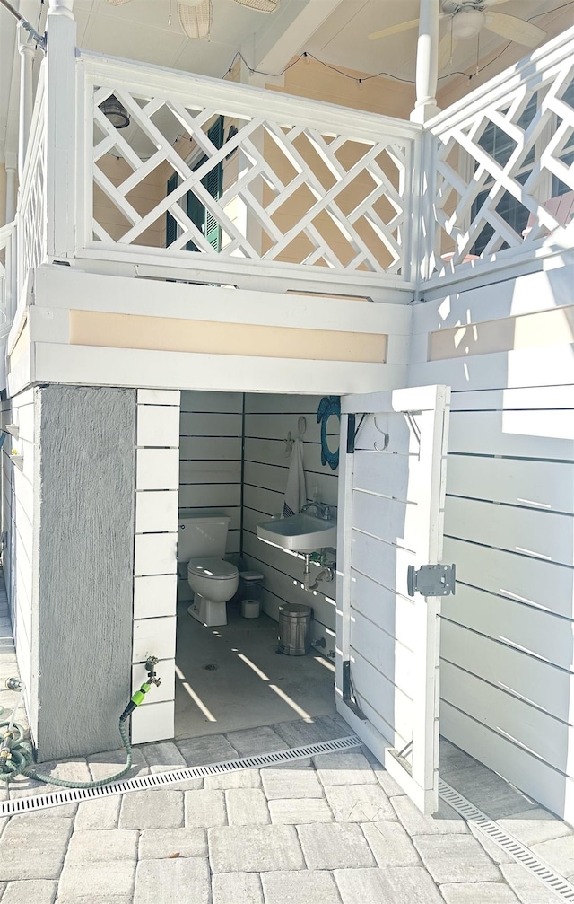 room details featuring sink and wood walls