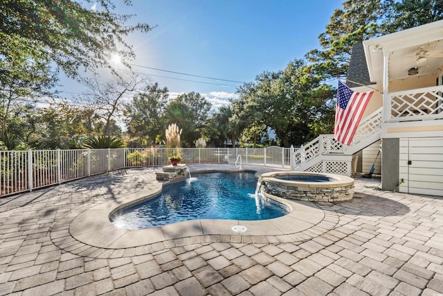 view of swimming pool featuring stairs, a patio area, a pool with connected hot tub, and fence