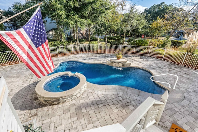 view of pool with a patio area and an in ground hot tub