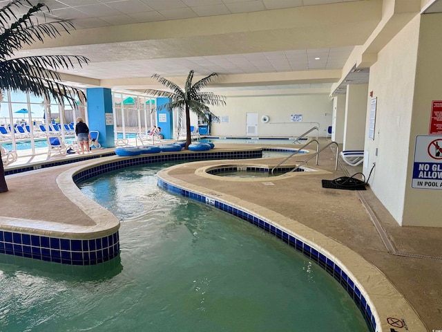 view of pool with an indoor in ground hot tub and a patio area