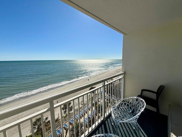 balcony with a view of the beach and a water view