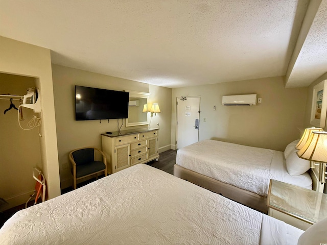 bedroom featuring a wall mounted air conditioner and wood-type flooring