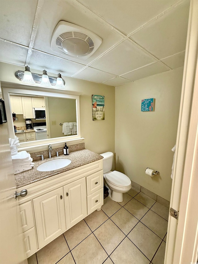 bathroom featuring toilet, vanity, and tile patterned floors