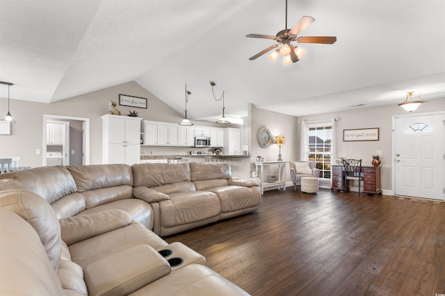 living room featuring vaulted ceiling, dark wood finished floors, and ceiling fan