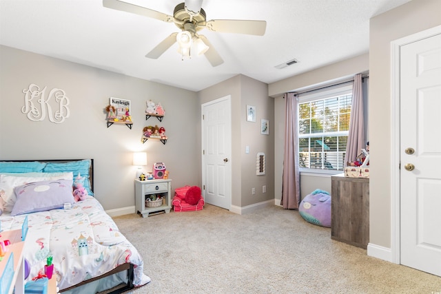 bedroom with a ceiling fan, baseboards, visible vents, and carpet flooring