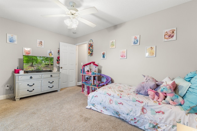 carpeted bedroom with baseboards and a ceiling fan