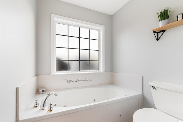 full bathroom with a whirlpool tub and toilet