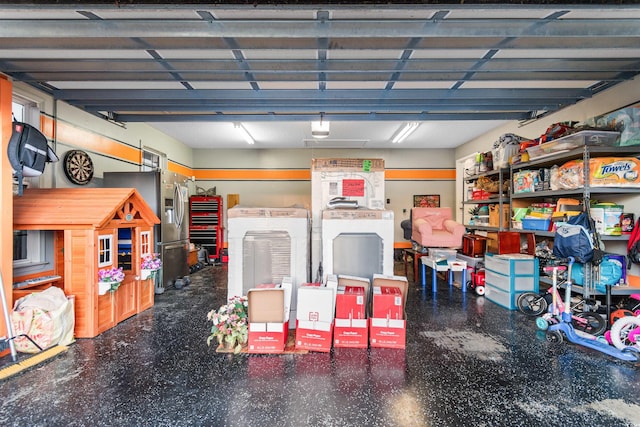 garage with stainless steel refrigerator with ice dispenser