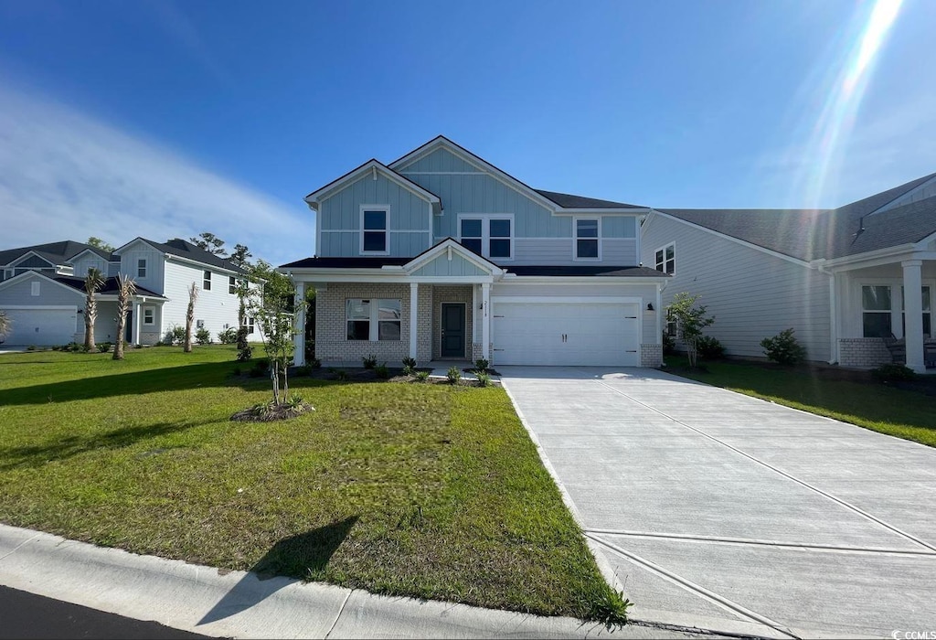 view of front of home with a garage and a front yard