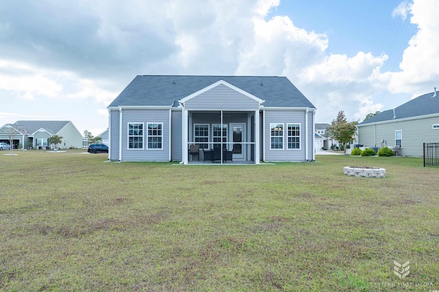 back of house with a sunroom and a yard