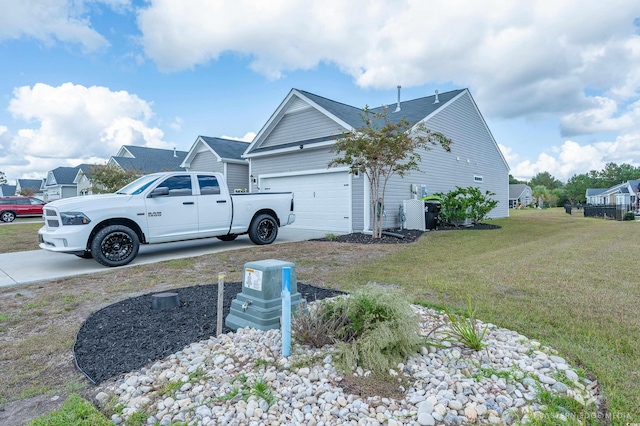 view of side of home featuring a yard and a garage