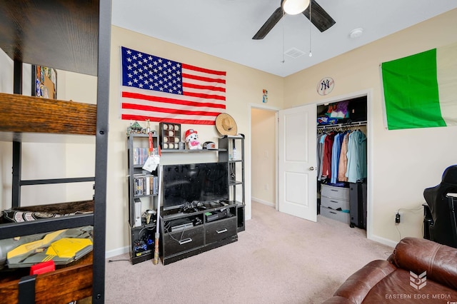 interior space featuring light carpet, a closet, and ceiling fan