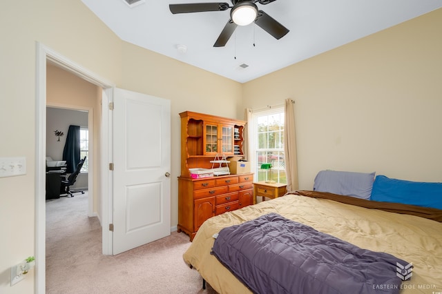 bedroom with light carpet and ceiling fan