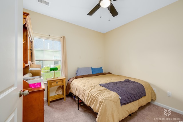 bedroom with ceiling fan and light carpet