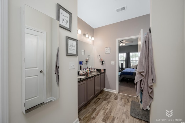 bathroom featuring vanity, hardwood / wood-style flooring, and ceiling fan