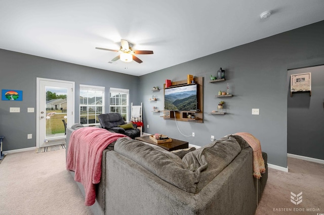 carpeted living room with ceiling fan