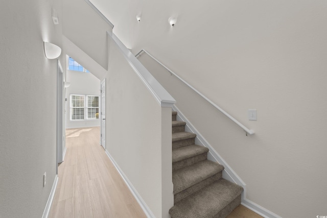 stairs with hardwood / wood-style flooring