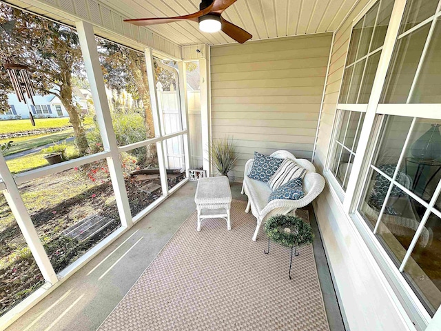 sunroom / solarium with ceiling fan and wood ceiling