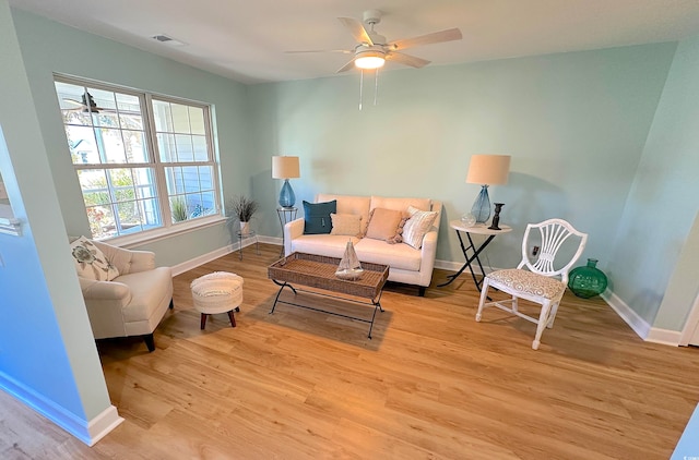 living room with ceiling fan and light hardwood / wood-style floors