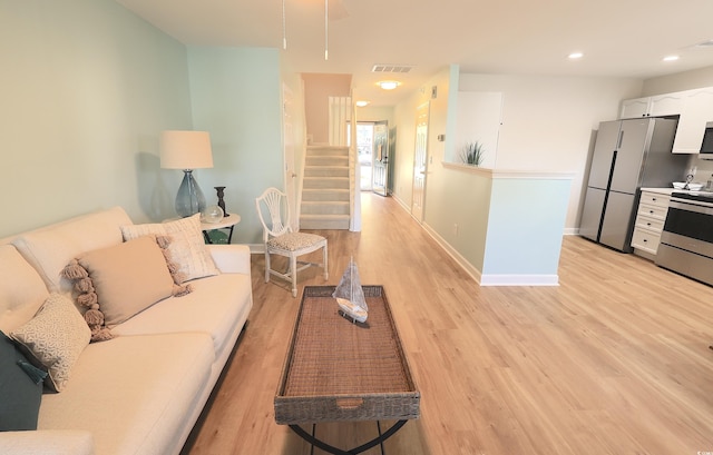 living room with light hardwood / wood-style floors