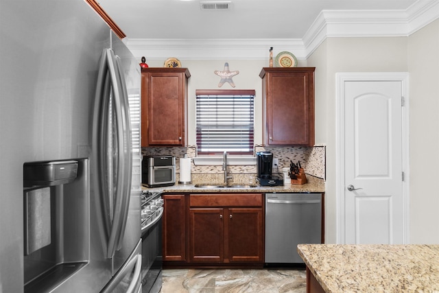 kitchen with backsplash, sink, ornamental molding, light stone counters, and stainless steel appliances