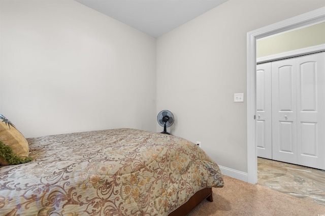 carpeted bedroom with a closet