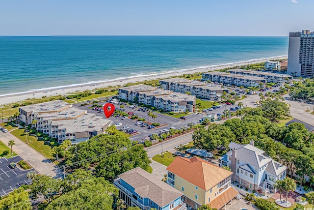 aerial view with a water view and a beach view