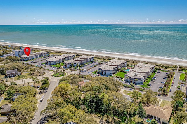 drone / aerial view featuring a water view and a view of the beach