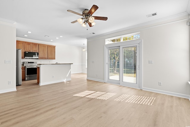 unfurnished living room featuring ornamental molding and light hardwood / wood-style floors