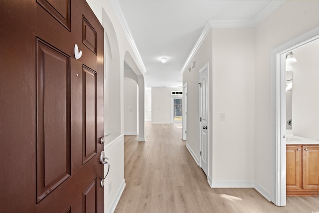 hallway featuring crown molding and light wood-type flooring