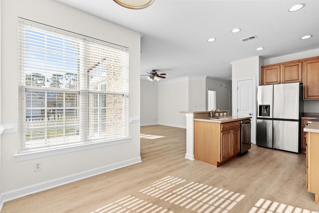 kitchen featuring a healthy amount of sunlight, appliances with stainless steel finishes, and light wood-type flooring