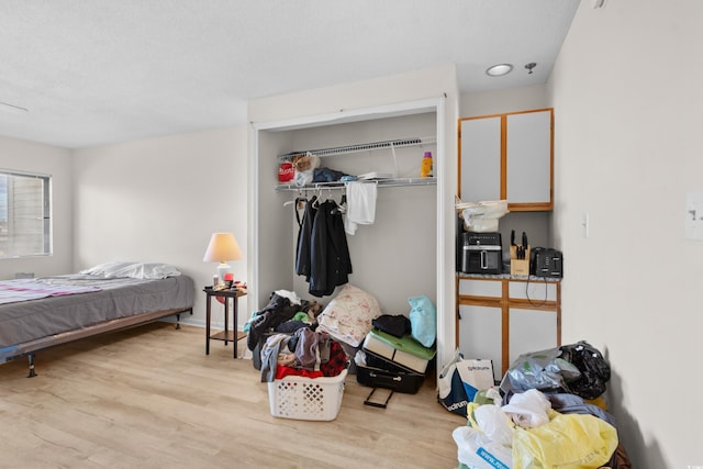 bedroom with a closet and light hardwood / wood-style floors