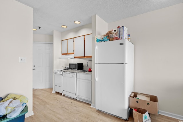 kitchen featuring a textured ceiling, white cabinetry, light hardwood / wood-style flooring, and white appliances