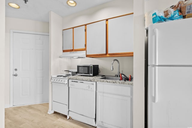 kitchen with light hardwood / wood-style floors, white cabinetry, white appliances, and sink