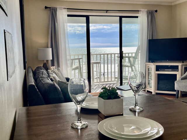 balcony with a water view and a beach view