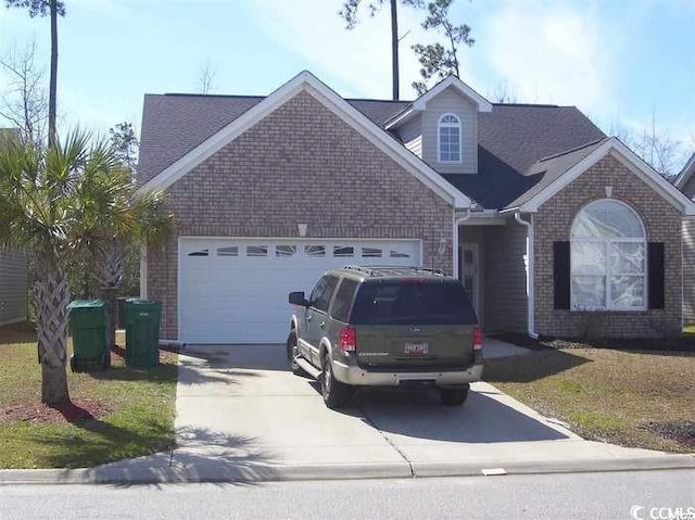 view of front of property with a front yard and a garage