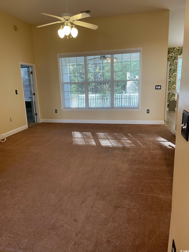 unfurnished room with carpet flooring and ceiling fan