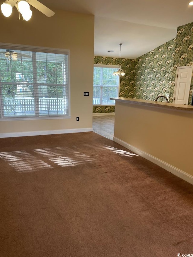 323 Sea Turtle Dr, Myrtle Beach, SC 29588 - empty room with baseboards, carpet flooring, ceiling fan, wallpapered walls, and a chandelier