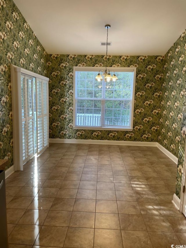 323 Sea Turtle Dr, Myrtle Beach, SC 29588 - unfurnished dining area featuring healthy amount of natural light, a chandelier, tile patterned flooring, baseboards, and wallpapered walls