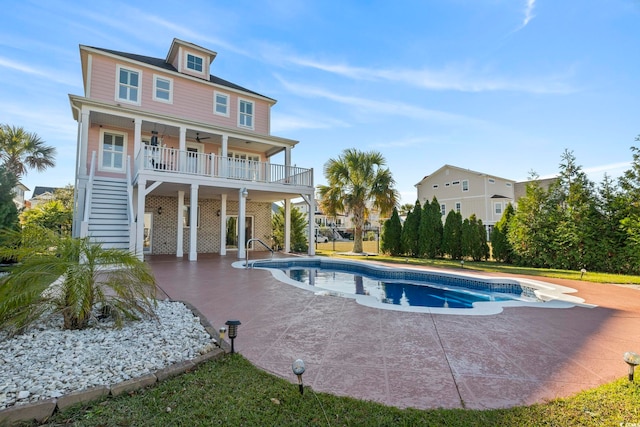 338 Harbour View Dr, Myrtle Beach, SC 29579 - rear view of house featuring ceiling fan, stairs, a patio area, and an outdoor pool